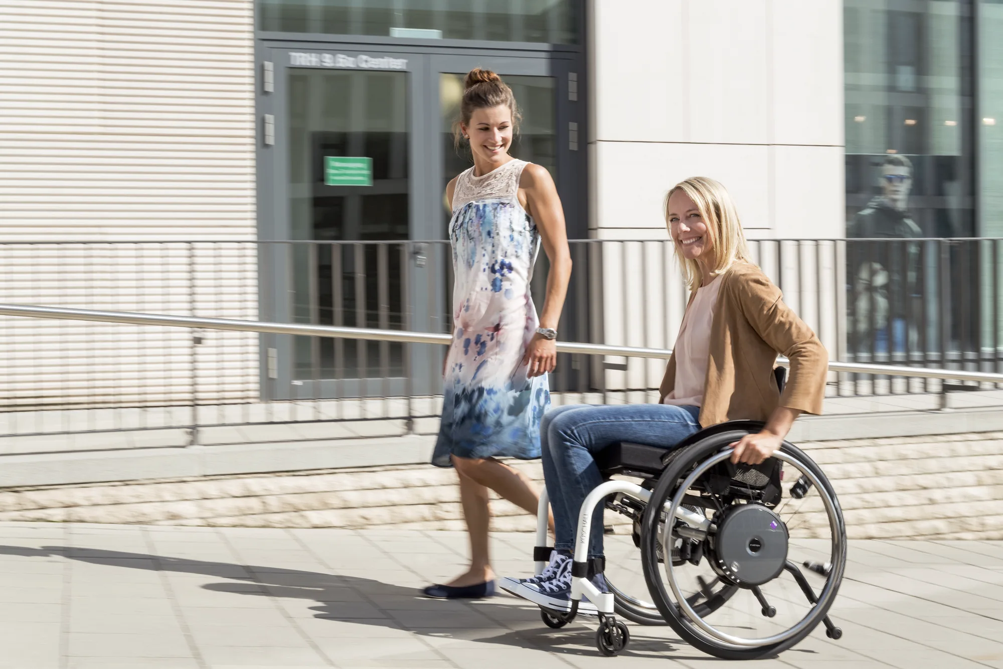 Rollstuhlfahrerin mit e-motion M25 im Gespräch in der Stadt